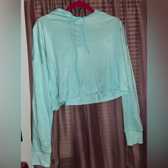 Turquoise back and multi-color women’s hoodie.